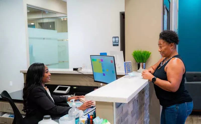 woman scheduling her next dental appointment at 10 Day Smiles